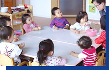 Photo: Six children sitting at a round table