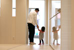 Photo: Back view of parent and child holding hands